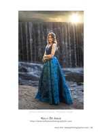 graduate in blue gown before a waterfall portrait photography