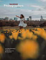 woman twirling among daffodils before the Raleigh skyline back cover portrait photography