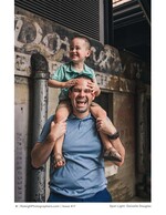 father laughing with his son on his shoulders family portrait photography