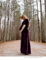 pregnant woman in velvet gown on a pine-lined path maternity photography