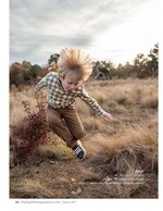 boy jumping through tall grass with hair standing on end children's portrait photography