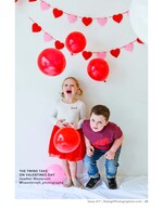 twins posing with red balloons and heart garland children's portrait photography