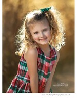 curly-haired girl in plaid dress backlit at golden hour children's portrait photography