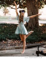 graduate in a cap kicking up her heel under a park tree senior portrait photography