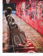 woman in a vintage dress beside a graffiti-covered tunnel wall fashion photography