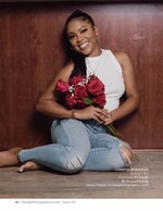 woman seated on the floor holding a bouquet of red roses portrait photography