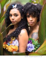 two models with floral bodices framed by tropical leaves fashion photography