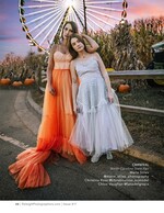 two models in flowing gowns before a lit ferris wheel fashion photography
