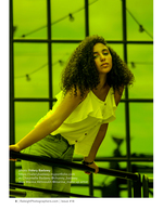 woman on a green-lit rooftop railing portrait photography