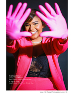 woman in a pink blazer forming a heart with her hands portrait photography