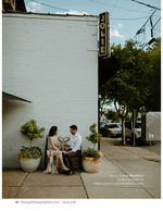 couple toasting on a city sidewalk portrait photography