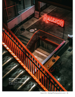 illuminated Raleigh neon sign above a stairwell cityscape photography