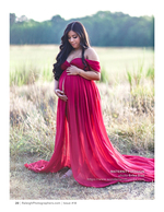 pregnant woman in a red gown in a grass field maternity photography