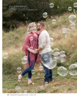 couple kissing surrounded by floating bubbles portrait photography