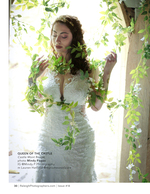 bride draped in vines at a stone archway portrait photography
