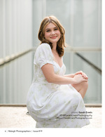 young woman in floral dress crouching on a terrace portrait photography