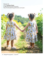 two young sisters holding hands in a sunflower field family portrait photography