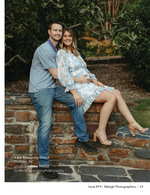 expecting couple seated on a stone wall maternity photography