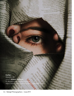 eye peeking through torn newspaper conceptual portrait photography